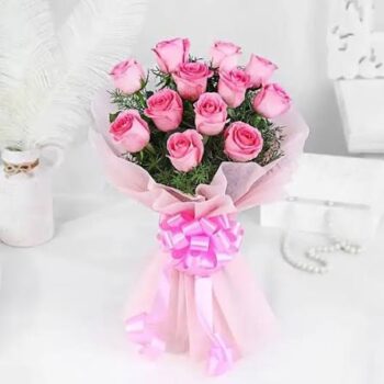 12 pink roses with pink paper and pink ribbon