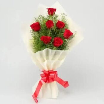 7 red roses with white paper packing